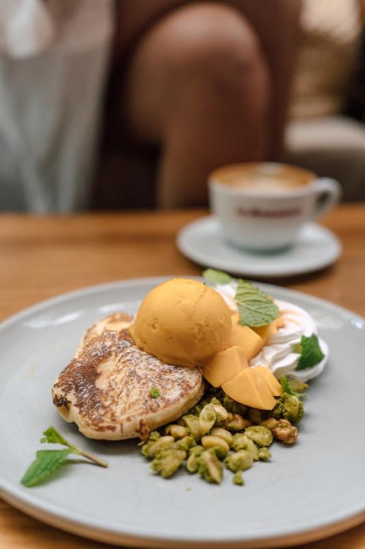 Fluffy tropical hotcakes with mango sorbet, mint, and toasted nuts